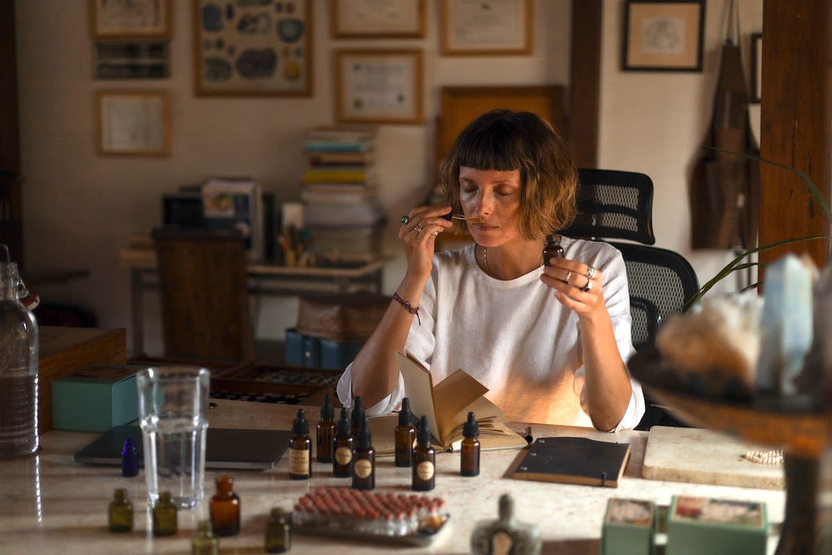 Participants engaging in an aromatherapy workshop at Goddess Retreats in Bali, surrounded by essential oils and calming ambiance.