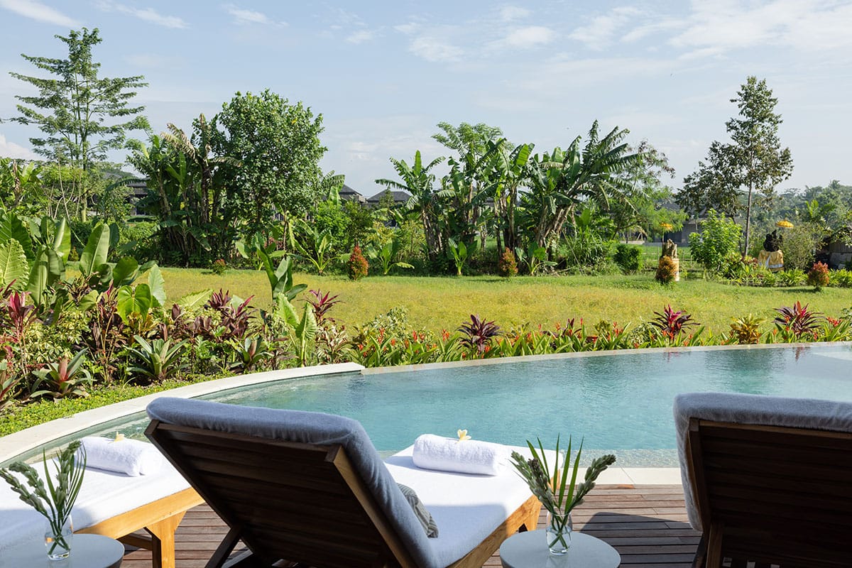 Bali retreat accommodation – Gaia Retreat Center Premium Pool View room in lush Ubud, surrounded by tropical nature.