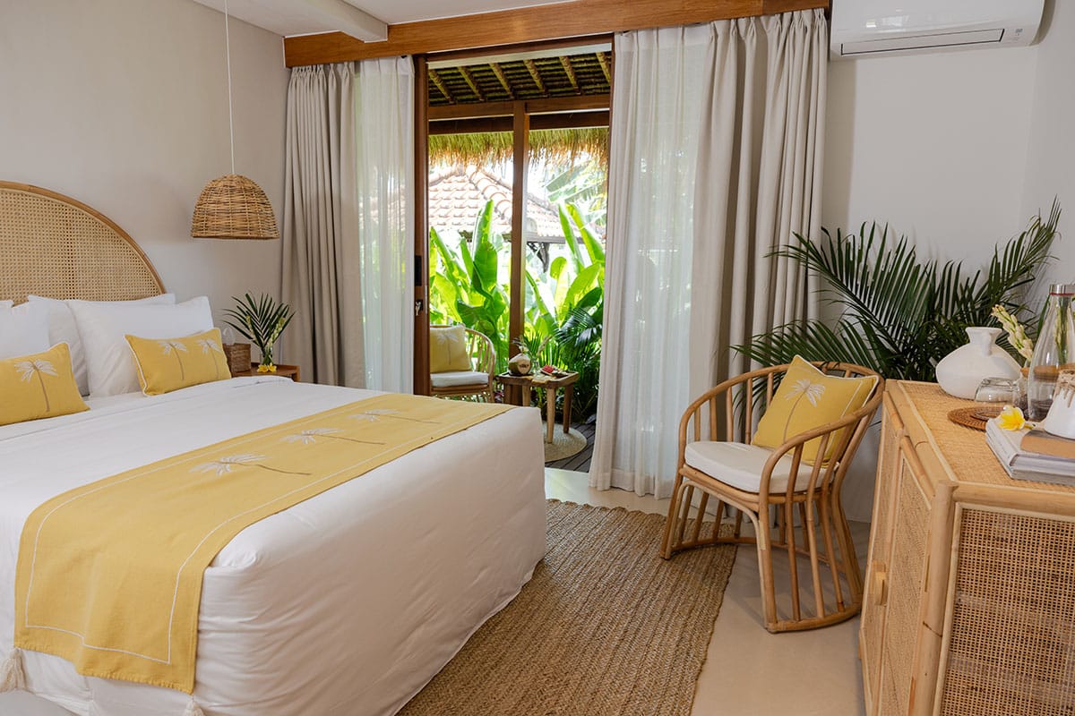 Interior of the Gaia Room at a Bali retreat in Ubud, showcasing a serene, tranquil atmosphere with natural wood furnishings, plush seating, and calming decor elements that promote relaxation and well-being.