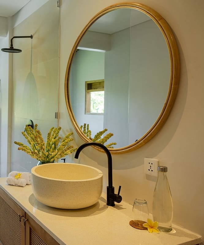 Open-air Gaia shower at a tranquil Bali retreat in Ubud, surrounded by lush tropical greenery.