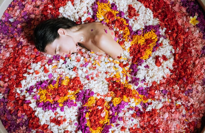 Beautiful flower mandala in a luxurious Bali ayurveda bath, with vibrant tropical flowers and calming water.
