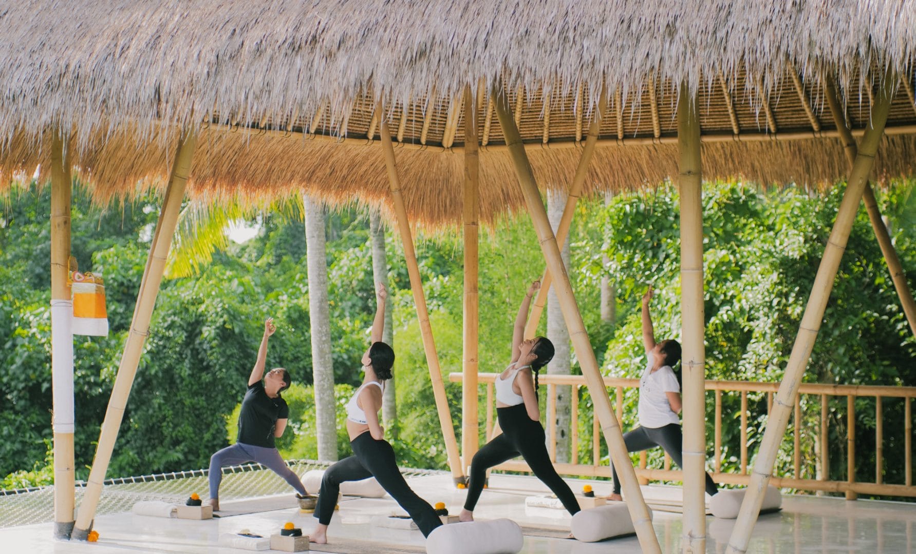 Spacious and serene yoga shala at Goddess Retreats, with wooden floors, large windows, and mats ready for a transformative yoga session