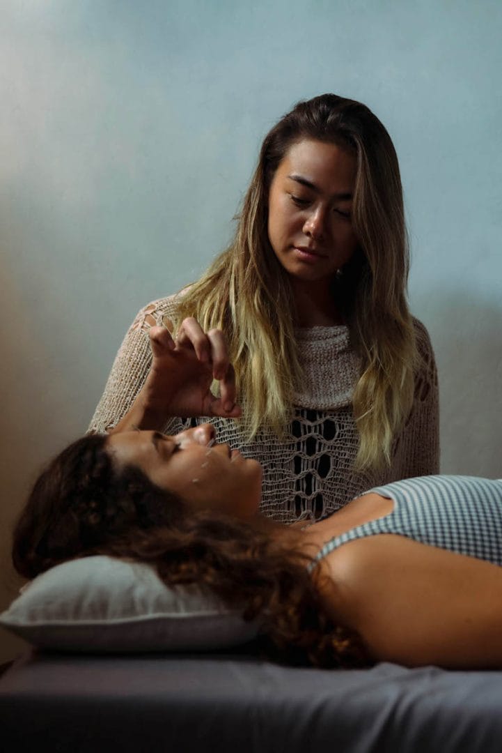 A woman receiving cosmetic acupuncture treatment with fine needles gently inserted into her face to promote skin rejuvenation and natural beauty