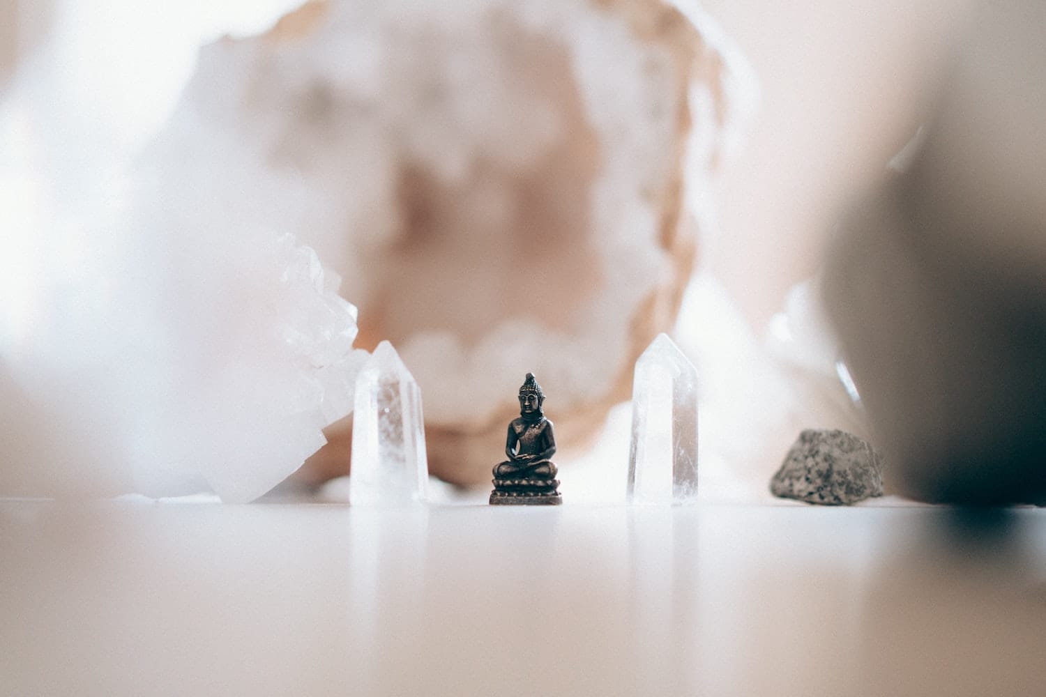 Crystal quartz healing with Buddha statue at a spiritual retreat – energy cleansing and meditation