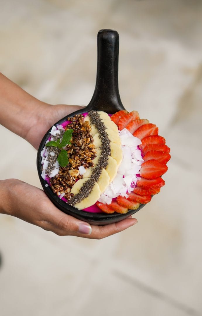 "Vibrant dragon fruit smoothie bowl served at Bali Goddess Retreats, topped with fresh tropical fruits and coconut.