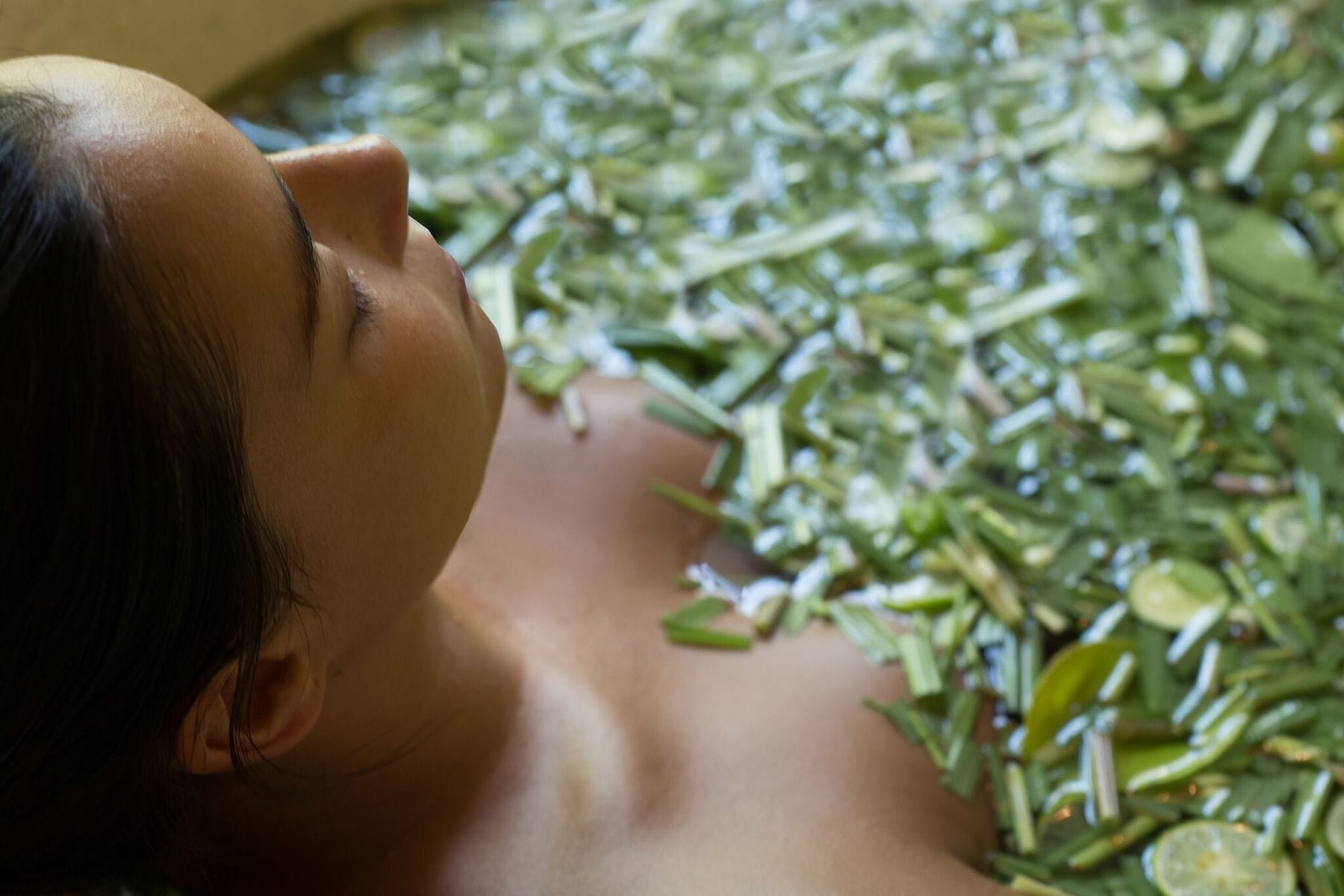 Serene herbal spa bath at a Ubud health retreat, surrounded by lush greenery and relaxing ambiance.