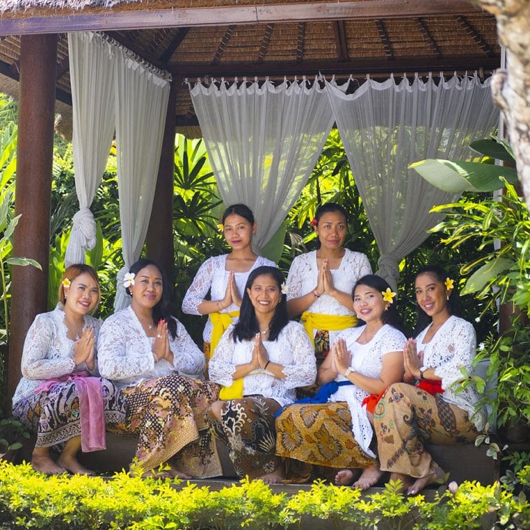 Friendly hostess welcoming guests to a Goddess Retreat, embodying warmth and hospitality in a serene, welcoming environment.