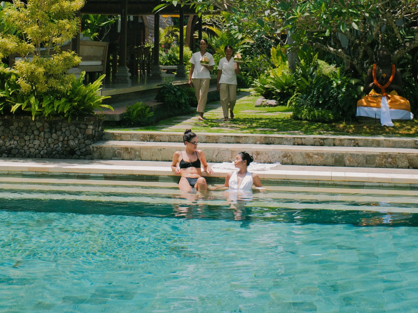 Two females enjoy moment at poolside